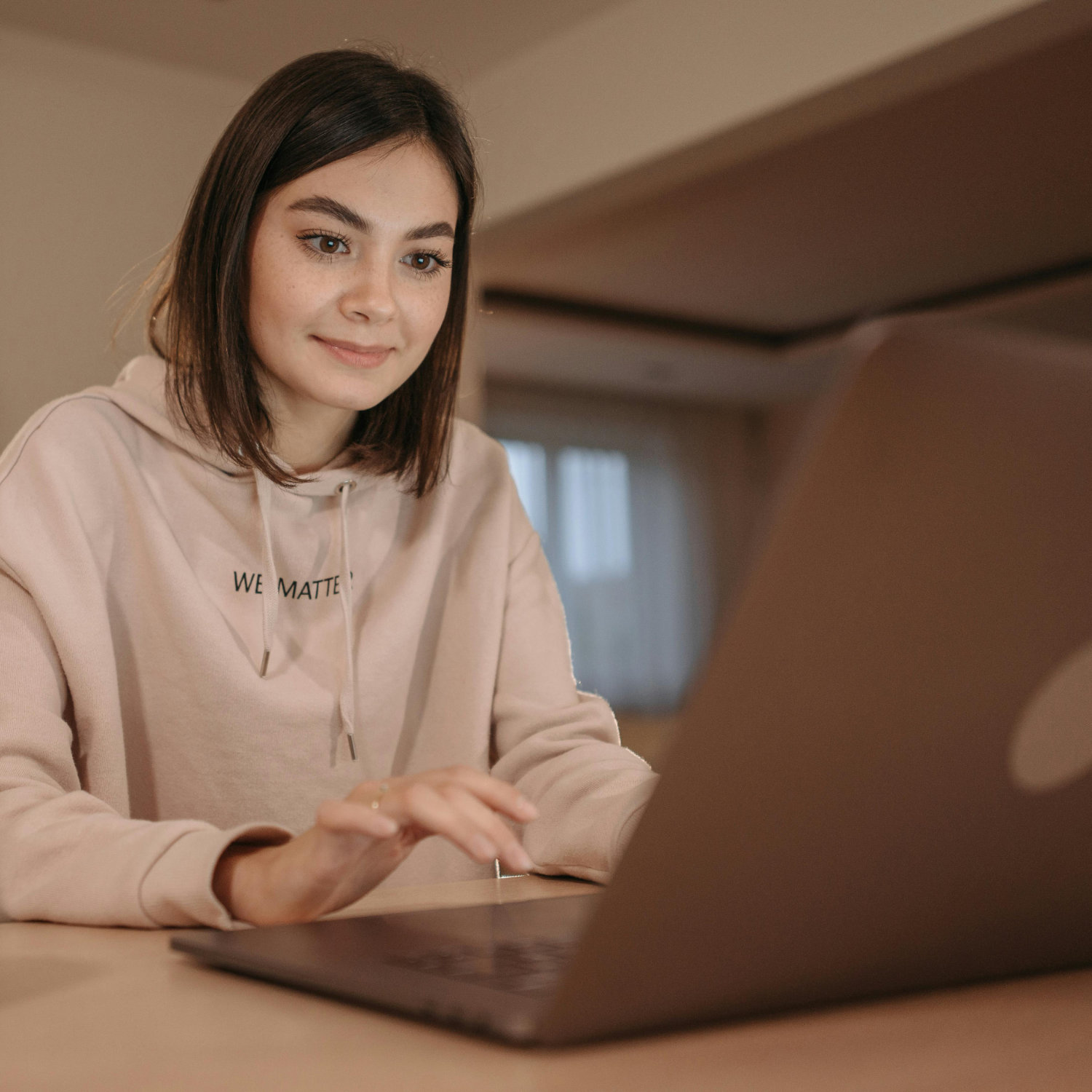 Young woman working on her laptop at a table