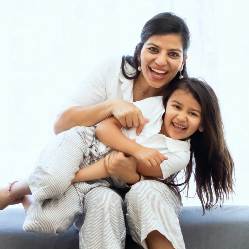 A mom and daughter smiling and having fun